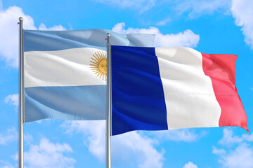 France and Argentina national flag waving in the windy deep blue sky. Diplomacy and international relations concept.