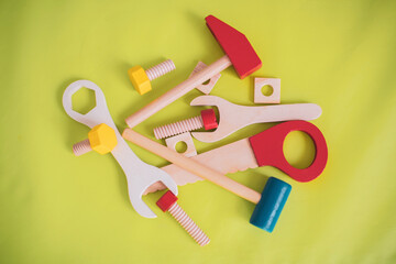 Workshop wooden toy tools on a green background