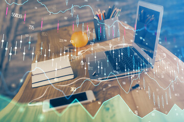 Financial chart drawing and table with computer on background. Multi exposure. Concept of international markets.