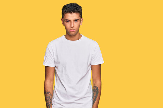 Young handsome african american man wearing casual white tshirt skeptic and nervous, frowning upset because of problem. negative person.