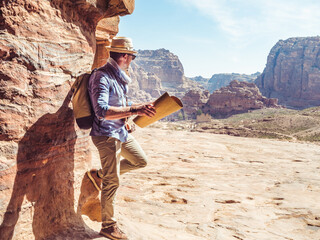 Fashionable tourist, exploring the sights of the ancient, fabulous city of Petra in Jordan. Colorful photos. Concept of leisure, vacation and travel	
