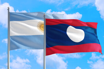 Laos and Argentina national flag waving in the windy deep blue sky. Diplomacy and international relations concept.