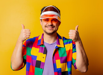 style guy in 90s shirt and hat on yellow background