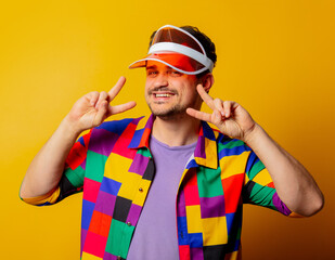 style guy in 90s shirt and hat on yellow background