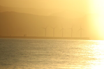 Wind turbines at sunset on the Basque shore