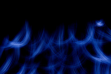 Wallpaper with bright curved lines and flame of blue color. Background with copy space for screen or banner text. Lightpainting effect