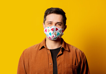 portrait of guy in face mask on yellow background