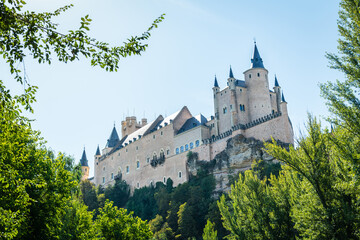 Fototapeta na wymiar Low angle view of the Alcazar, a stone castle-palace located in the walled old city of Segovia, Spain.