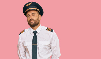 Handsome man with beard wearing airplane pilot uniform depressed and worry for distress, crying angry and afraid. sad expression. © Krakenimages.com
