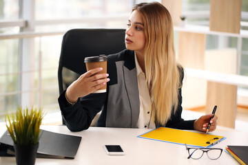 Young happy smiling businesswoman working at office