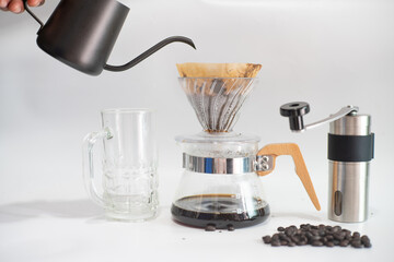 Drip brewing coffee on paper filtered pouring water over roasted with coffee bean