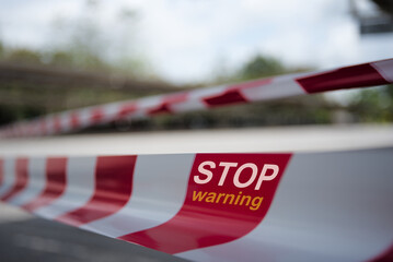 Fototapeta premium stop sign on a red and white rope .Concept stop checking