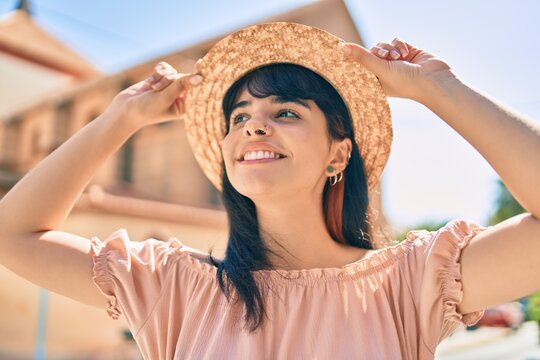 Young hispanic tourist girl wearing summer style walking at the city.