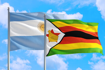 Zimbabwe and Argentina national flag waving in the windy deep blue sky. Diplomacy and international relations concept.