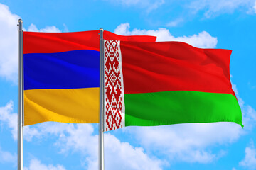 Belarus and Armenia national flag waving in the windy deep blue sky. Diplomacy and international relations concept.