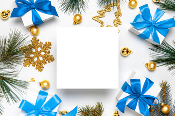 Christmas background white. White gift box with blue ribbon, New Year balls and Christmas tree in xmas composition on white background for greeting card. Flat lay, top view, copy space.