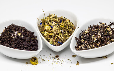 three bowls of loose tea on white background