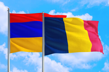 Chad and Armenia national flag waving in the windy deep blue sky. Diplomacy and international relations concept.