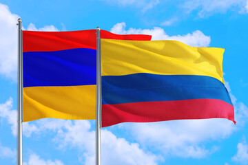 Fototapeta na wymiar Colombia and Armenia national flag waving in the windy deep blue sky. Diplomacy and international relations concept.