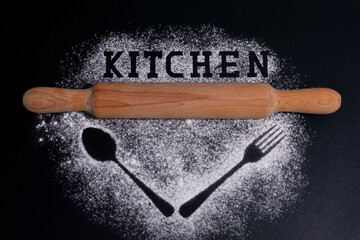 Images of fork and spoon on a white flour background. Lettering-kitchen and rolling pin on top.