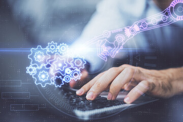 Multi exposure of data internet theme hologram with man working on computer on background. Concept of innovation.