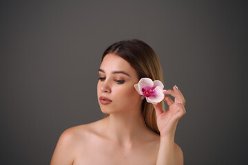 Obraz na płótnie Canvas Woman holds beauty flower. skin care treatment
