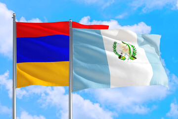 Naklejka na ściany i meble Guatemala and Armenia national flag waving in the windy deep blue sky. Diplomacy and international relations concept.
