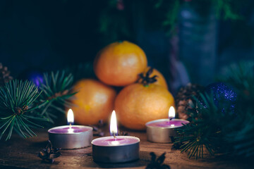 Christmas composition with tangerines, Christmas tree and candles