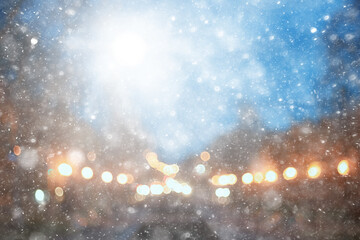 abstract snow blurred background city lights, winter holiday new year