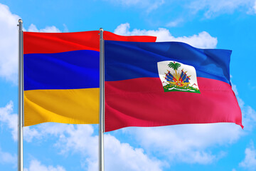 Haiti and Armenia national flag waving in the windy deep blue sky. Diplomacy and international...