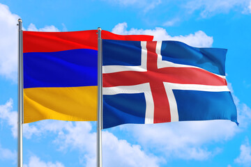 Iceland and Armenia national flag waving in the windy deep blue sky. Diplomacy and international relations concept.