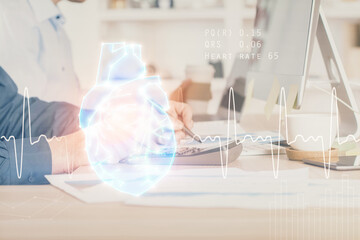 Heart drawing with man working on computer on background. Medical concept. Double exposure.