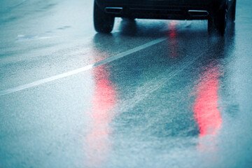 The reflection of moving car lights on wet asphalt