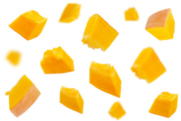 Falling pumpkin slices isolated on a white background, selective focus. Set of pumpkin slices in the air. Pumpkin slices fall. Pumpkin slices in the air on a white background.