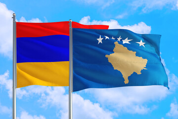 Kosovo and Armenia national flag waving in the windy deep blue sky. Diplomacy and international relations concept.