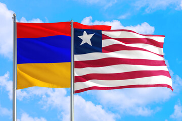 Liberia and Armenia national flag waving in the windy deep blue sky. Diplomacy and international relations concept.