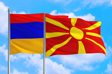 Macedonia and Armenia national flag waving in the windy deep blue sky. Diplomacy and international relations concept.