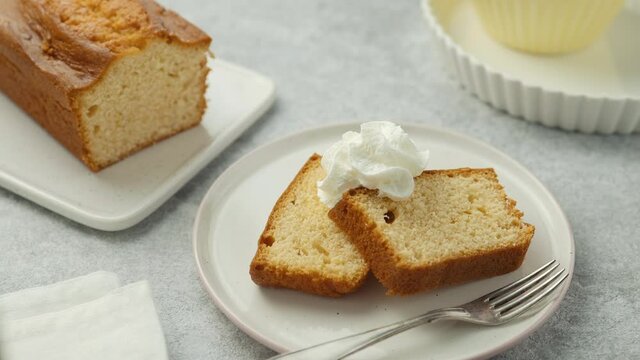 The chef decorates the lemon homemade cupcake with whipped cream