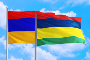 Mauritius and Armenia national flag waving in the windy deep blue sky. Diplomacy and international relations concept.