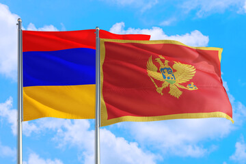 Montenegro and Armenia national flag waving in the windy deep blue sky. Diplomacy and international relations concept.