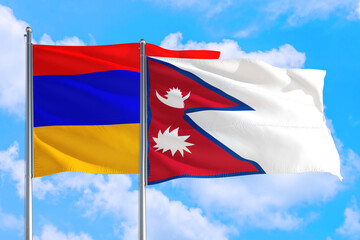 Fototapeta na wymiar Nepal and Armenia national flag waving in the windy deep blue sky. Diplomacy and international relations concept.