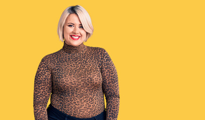 Young blonde plus size woman wearing casual leopard t-shirt looking positive and happy standing and...
