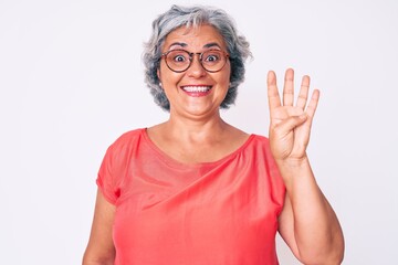 Senior hispanic grey- haired woman wearing casual clothes and glasses showing and pointing up with fingers number four while smiling confident and happy.