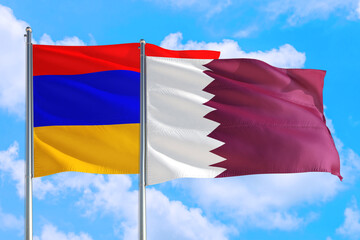Qatar and Armenia national flag waving in the windy deep blue sky. Diplomacy and international relations concept.