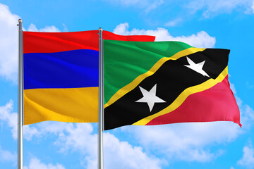 Saint Kitts And Nevis and Armenia national flag waving in the windy deep blue sky. Diplomacy and international relations concept.