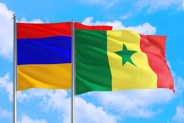 Senegal and Armenia national flag waving in the windy deep blue sky. Diplomacy and international relations concept.