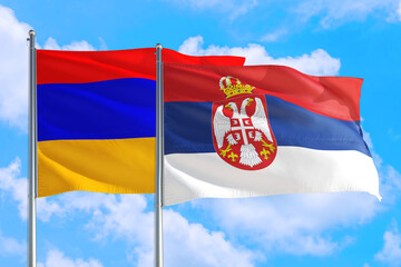 Serbia and Armenia national flag waving in the windy deep blue sky. Diplomacy and international relations concept.