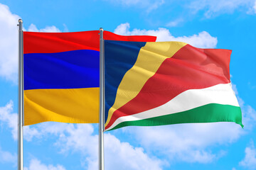 Seychelles and Armenia national flag waving in the windy deep blue sky. Diplomacy and international relations concept.
