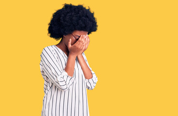 Fototapeta na wymiar Young african american woman wearing casual clothes and glasses with sad expression covering face with hands while crying. depression concept.