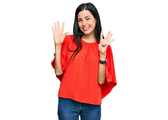Beautiful young woman wearing casual clothes showing and pointing up with fingers number nine while...